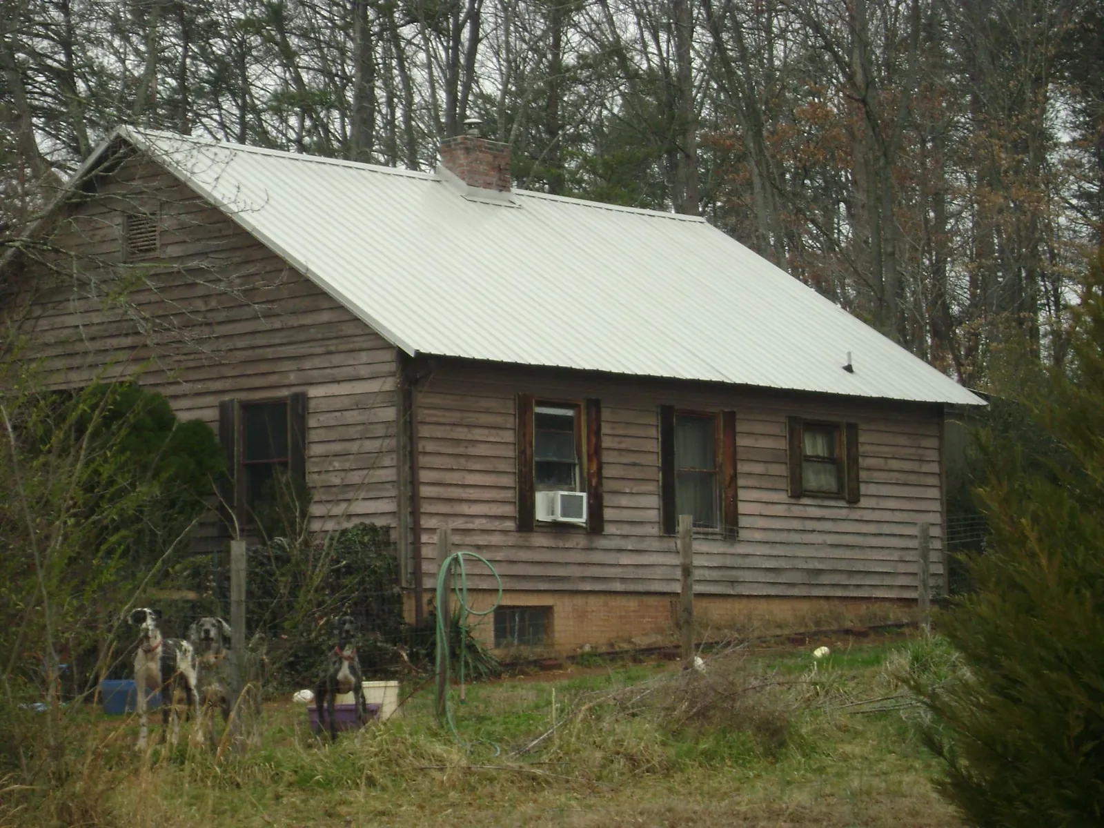 White metal roof on an old wood sided farmhouse, from a Metal Roof Installation job in Grafton